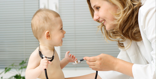 doctor using a stethocope on a baby